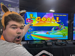 Justin pogchamping in front of a Mario kart screen, where he won first place.